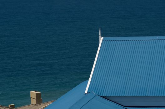 Roof and ocean blue and white Mediteranean style holiday house