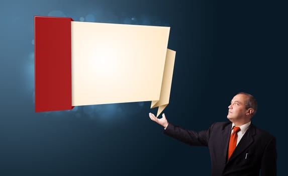 businessman in suit presenting modern origami copy space
