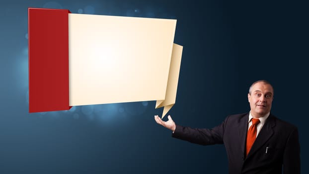 businessman in suit presenting modern origami copy space