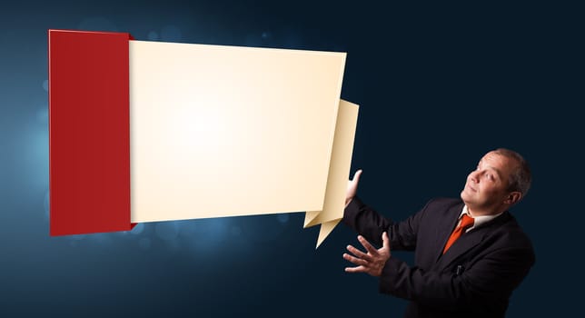 businessman in suit presenting modern origami copy space