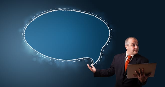 funny businessman in suit holding a laptop and presenting speech bubble copy space