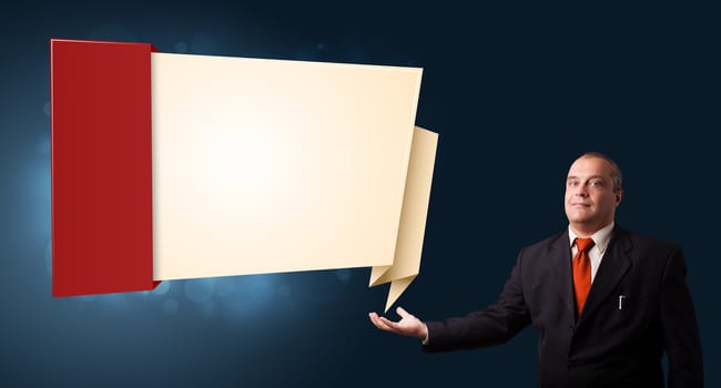 businessman in suit presenting modern origami copy space