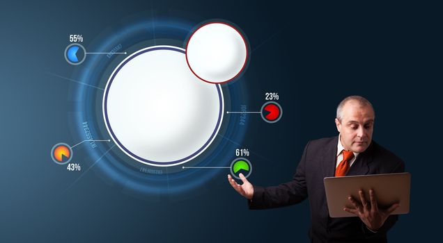 businessman in suit holding a laptop and presenting abstract modern pie chart with copy space