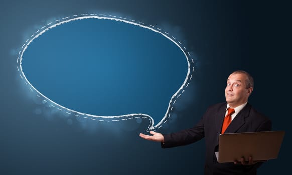 funny businessman in suit holding a laptop and presenting speech bubble copy space