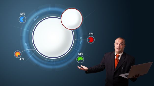 businessman in suit holding a laptop and presenting abstract modern pie chart with copy space