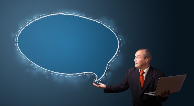 funny businessman in suit holding a laptop and presenting speech bubble copy space