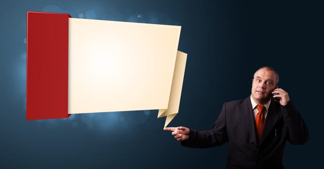 businessman in suit making phone call and presenting modern origami copy space