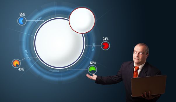 businessman in suit holding a laptop and presenting abstract modern pie chart with copy space