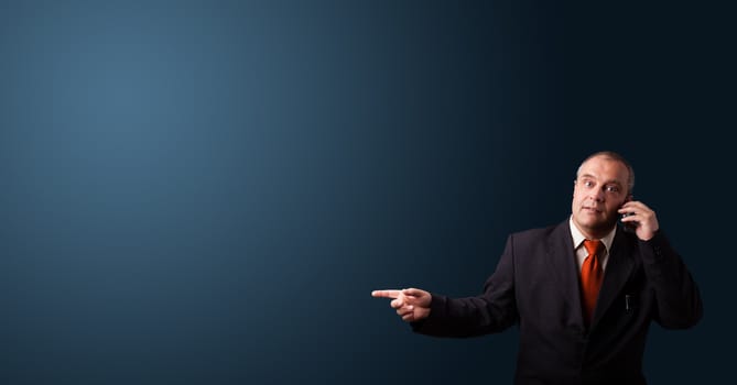 businessman in suit making phone call and presenting copy space