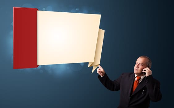 businessman in suit making phone call and presenting modern origami copy space