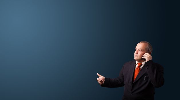 businessman in suit making phone call and presenting copy space