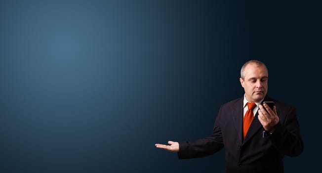 businessman in suit making phone call and presenting copy space