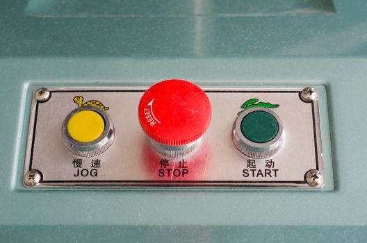 Industrial machine start stop and jog buttons in english and chinese letters