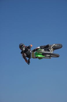 Moto X Freestyle rider side jump high in sky