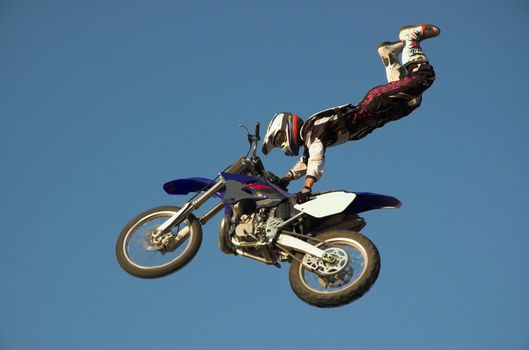 Moto X Freestyle rider high in sky with legs pointing up