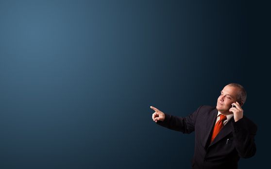 businessman in suit making phone call and presenting copy space