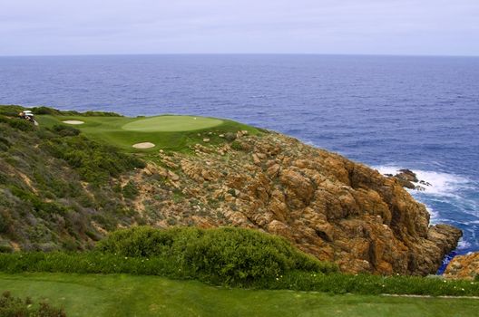 Perfect golf green hole at the sea