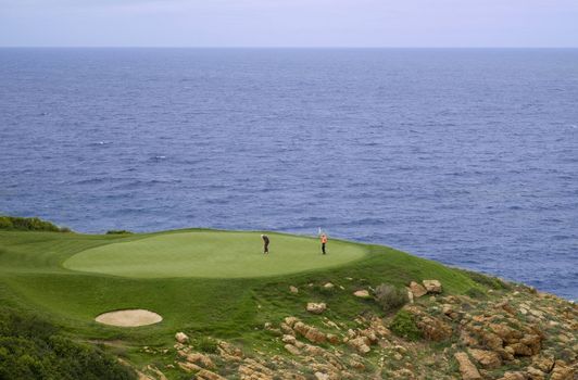 Perfect golf green hole at the sea