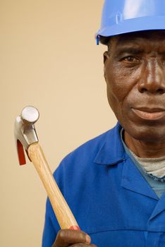 Construction worker holding hammer, builder, handyman