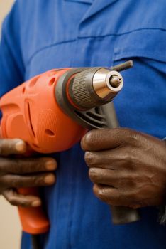 African American Construction Worker Holding Power Tool in Hands