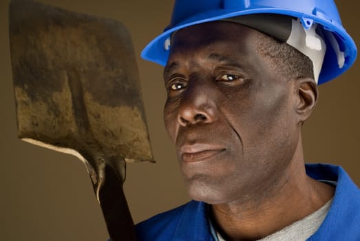 African American Construction Worker Resting Shovel on His Shoulder