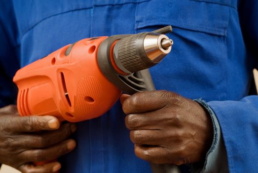 African American Construction Worker Holding Power Tool in Hands