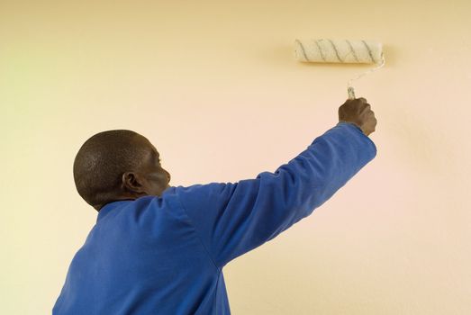 African American Construction Worker Painting a Wall