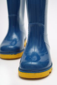 Childs blue and yellow wellington rain boots on white