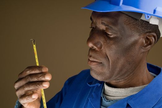African American Construction Worker Holding a Tape Measure