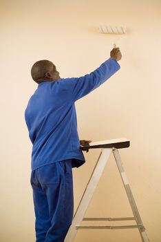 African American Construction Worker Painting a Wall