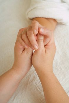 Beauty therapist hands massaging hands or manicure