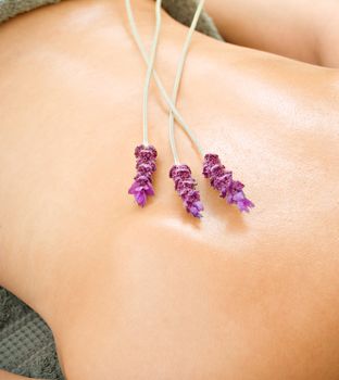 Spa woman with lavender flower waiting for massage
