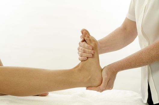 Kinesiologist or physiotherapist treating foot tibialis