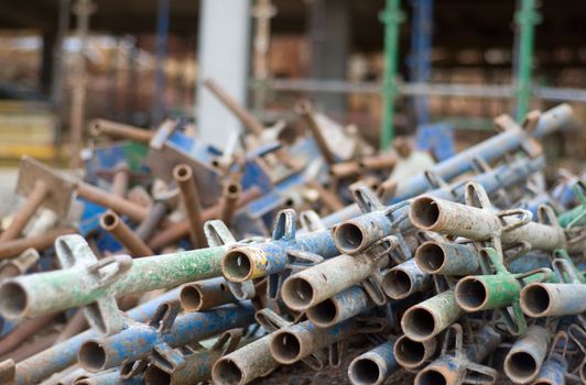 Pile of old construction scaffold on site