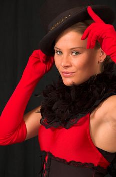 Moulin Rouge model with hat and red gloves holding hat on head