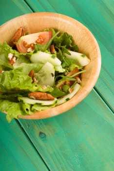 Healthy fresh green salad in wooden bowl