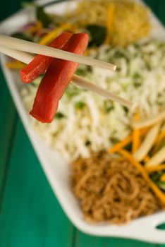 Chop sticks and raw thai food stir fry