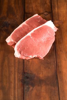 Fresh raw beef meat steak on wooden table or cutting board