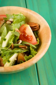 Healthy fresh green salad in wooden bowl