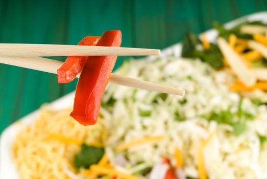 Chop sticks and raw thai food stir fry