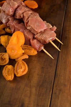 Raw meat beef kebab skewer with apricots