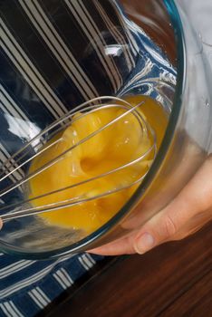 Woman cook or chef whisk, whisking or mixing egg mixture
