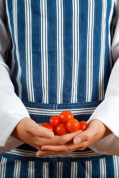 Woman chef or cook with tomato or tamatoes in her hands