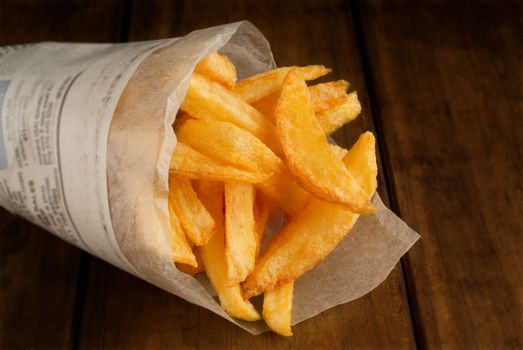 French fries in rolled newspaper packet or packaging