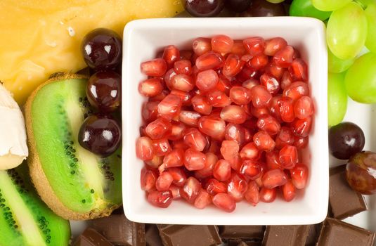 Cheese and fruit platter with pomegranate; grapes and kiwi fruit