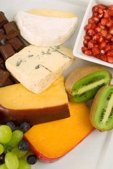 Cheese and fruit platter including kiwi and pomegranate