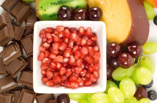 Cheese and fruit platter with pomegranate; grapes and kiwi fruit