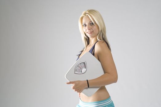 Slimming fit active woman happy with target weight scale