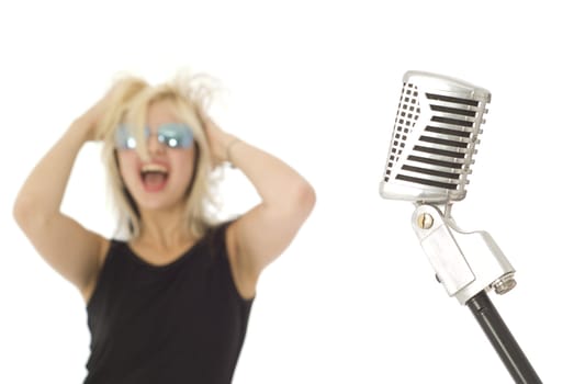 Retro microphone with rocking singer out of focus in background