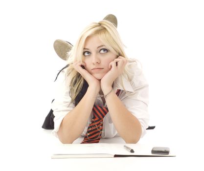 Pretty teenage school girl doing homework and cellphone